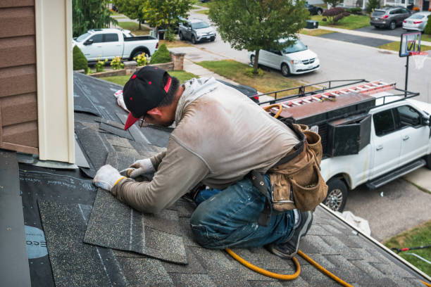Professional Roofing technician working in Plainville, MA